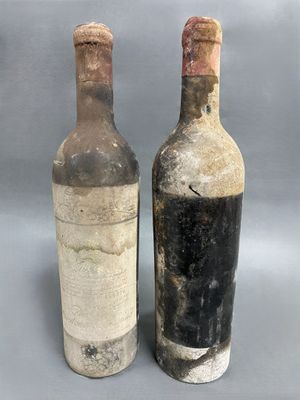 two bottles of wine sitting next to each other on a gray surface
