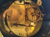 a clock that is sitting inside of a blue container