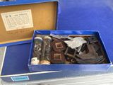 a blue box filled with assorted items sitting on a table