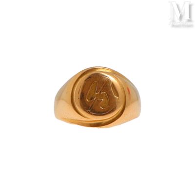 an image of a gold signet ring with a monogram on it