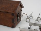 a small wooden box with tools on a white surface