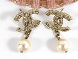 chanel earrings with pearls and crystals on a seashell