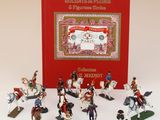 figurines de soldats à cheval, avec un livre rouge en arrière-plan