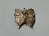 a silver butterfly that is sitting on top of a table