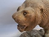 a statue of a bear that is on a rock