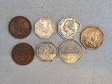 six different coins are arranged in a row on a blue surface