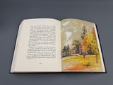 un livre ouvert dans lequel figure l'image d'un arbre