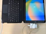 a laptop and a tablet sitting on a desk next to each other