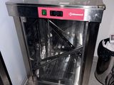a stainless steel oven sitting in the corner of a kitchen