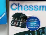 a box of chessmen on a table next to a box of chessmen