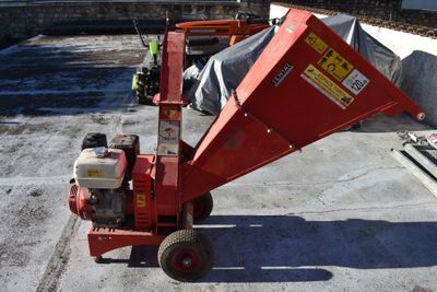 a small red machine that is sitting on the concrete