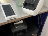 a printer and a cell phone sitting on a desk