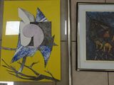 two framed pictures on the wall of a bathroom
