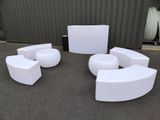 several white chairs and tables in front of a building