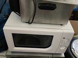 two microwaves stacked on top of each other on the floor