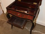 a small desk with a mirror on top of it