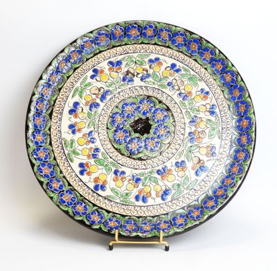 a decorative plate with blue flowers on it