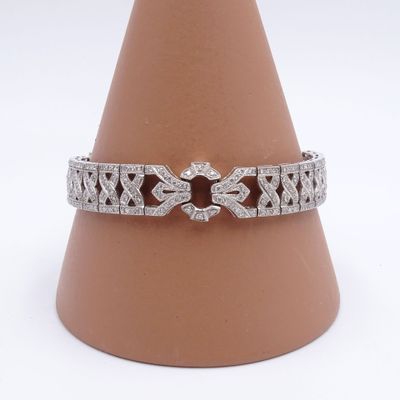 a close up of a diamond bracelet on a cone on a white background