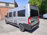 a silver van that is parked in a parking lot