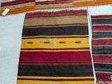several different colored rugs are laid out on a white surface