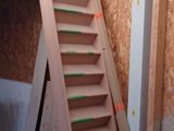 a wooden staircase next to a pallet of wood
