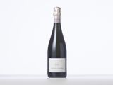 the bottle of wine is sitting on a white table