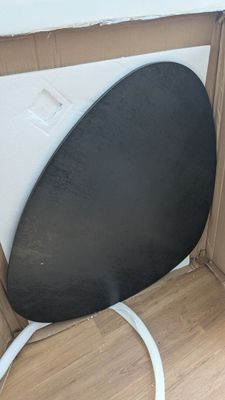 an image of a black chair in a cardboard box