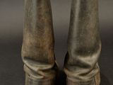 pair of old worn boots on a black background