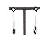 pair of black and white diamond earrings on a display stand
