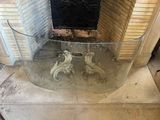 a glass table that is sitting in front of a fire place