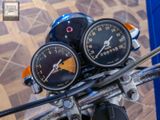 two gauges on the handlebars of a motorcycle