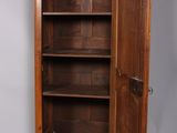 a wooden cabinet with a door open on a gray floor