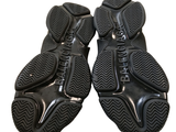 a pair of black shoes that are on top of each other