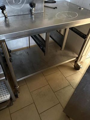 a stainless steel table with a laptop on it