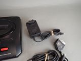 a video game console and a charger on a table
