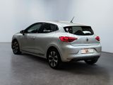 the rear end of a silver car parked in a white room