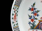 a plate with a picture of a man and a dog on it