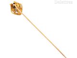 a close up of a gold pin with a flower on it