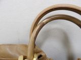 a brown purse sitting on top of a white table