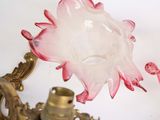 pair of pink and white glass flower sconces mounted on a gold plated sconce