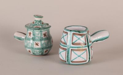 two teapots sitting next to each other on a table