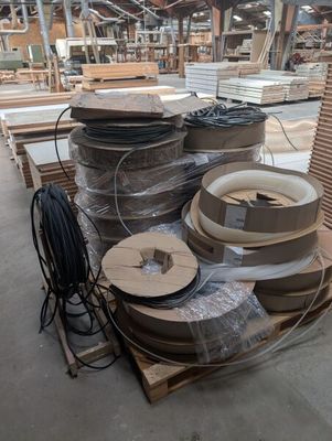many rolls of cardboard on a pallet in a warehouse