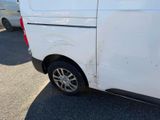 a white van that has been vandalized and is parked in a parking lot