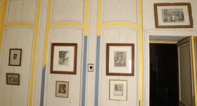 pictures hanging on the wall of a room with a doorway