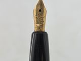 a close up of a fountain pen with a gold nib