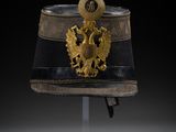 an officer ' s helmet with a gold eagle on the front