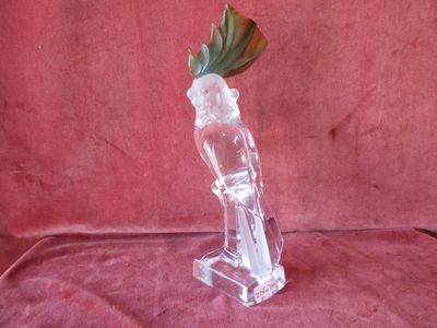 a glass vase with a flower in it on a red cloth