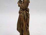 a bronze statue of a woman reading a book