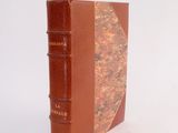 a brown book that is sitting on a white surface