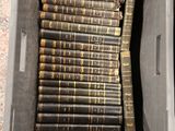 a box full of old books sitting on the floor